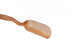 Macro shot of translucent brown tea scoop with a unique shovel shape for loose tea