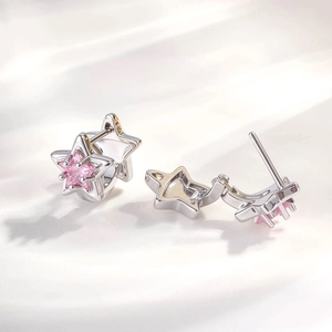 Silver star earrings featuring a pink zircon stone inlay in a minimalist chic style
