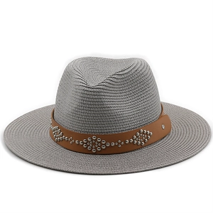 Close-up of grey straw fedora hat featuring a brown leather band with silver metal studs