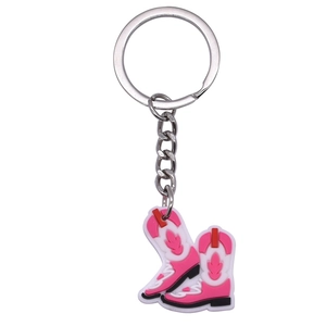 Detailed view of pink and white silicone cowboy boot keychain with metal ring