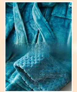 Detail of reinforced waist tie and textured embossed flannel fabric on warm bathrobe