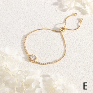 Close-up of 18K gold adjustable slider bracelet with sparkling round zircon center