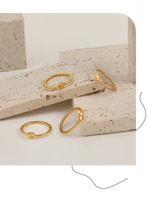 Detailed macro view of four vintage golden stackable rings with radial textured patterns