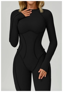 Close-up of black brushed yoga bodysuit featuring contouring seams and open back detail
