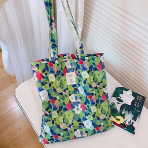 Detail of artistic oil painting floral pattern canvas tote bag with woven textile label