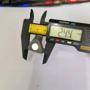 Detail shot showing 24.4mm measurement of a gray animal figurine fridge magnet part