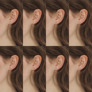 Collection of eight gold-plated silver stud earrings featuring geometric zircon designs