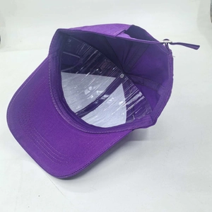 Detail view of purple baseball cap interior with white mesh and metal adjustment buckle