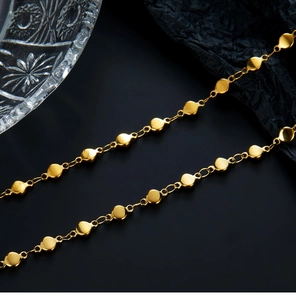 Macro view of 18K gold-plated stainless steel necklace with shiny round and oval links
