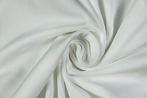 Detail shot of the white pleated fabric showing premium texture and soft drape of the dress