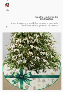 Detail showing white fabric Christmas tree skirt with green bow and reindeer print