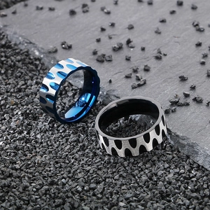 Mens titanium steel rings with wave pattern in black and blue on stone background