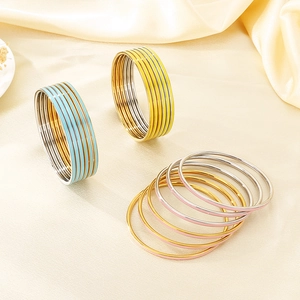 Set of stackable 3mm enamel bangles in blue yellow and pink for a stylish layered look