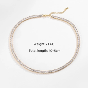 Detail showing gold tennis necklace with square zircons, lobster clasp and extension chain