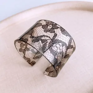 Chic acrylic open cuff bracelet featuring elegant black lace floral patterns for women