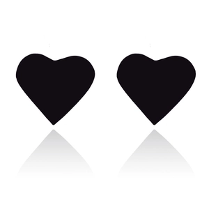Close-up of minimalist black heart stud earrings with smooth finish and reflective surface