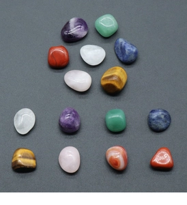 Detailed view of polished natural crystal stones like Amethyst and Rose Quartz in varied colors