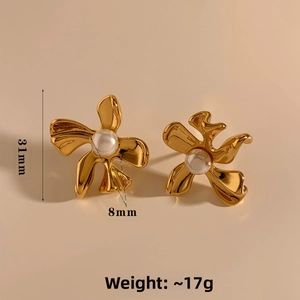 Detail view of gold flower earrings with 8mm pearl centerpiece and 31mm total height