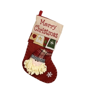 Classic red Christmas stocking with Merry Christmas text and Santa Claus patch on white background
