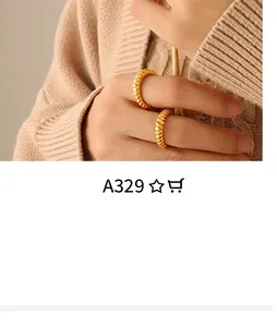 Detail of twisted rope golden rings worn against a beige knit sweater background