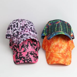 Macro shot showing four colorful tie-dye patterns on breathable fabric baseball caps
