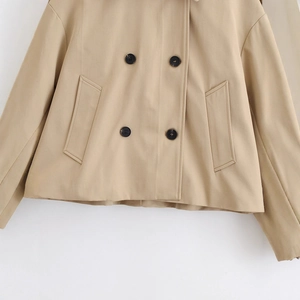 Short khaki double-breasted trench coat for women featuring side pockets and cotton fabric