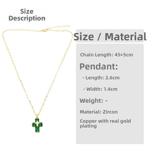 Detailed view of the 18K gold plated cross pendant with green zircon stones