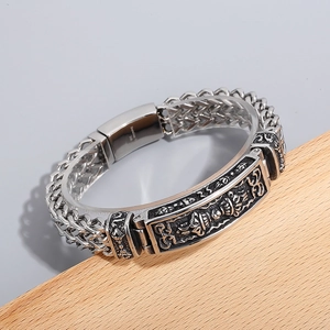 Macro shot of 316L stainless steel men's bracelet with totem relief and metal buckle