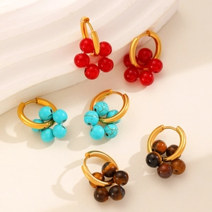Detailed shot of beaded stainless steel earrings in red, turquoise, and tiger eye colors