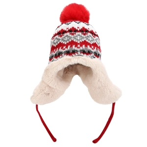 Close-up of the plush fleece lining and red faux fur pompom on a knitted trapper hat