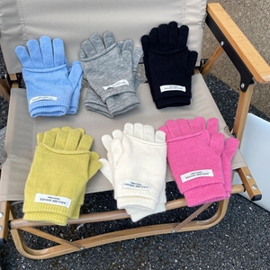 Detail of soft knit gloves in six colors on a camping chair with flap mittens design