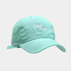Detailed view of Keep Going embroidery on mint green cotton twill baseball cap