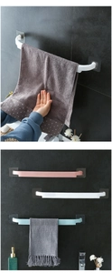Detail view of multi-color wall-mounted towel racks in white, pink, and light blue