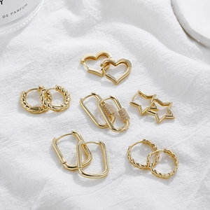 Detailed set of six gold-plated earrings featuring stars, hearts, and zircon accents