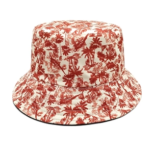 Close-up of red palm tree and exotic bird print on a wide brim bucket sun hat