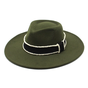Detail of dark green wool fedora hat with black grosgrain ribbon and white bead edging