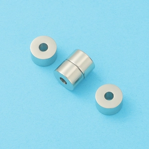 Macro shot of silver cylindrical metal beads with center holes for DIY jewelry