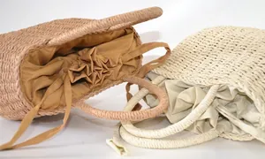 Detail view of woven straw basket bag with drawstring fabric lining and sturdy texture