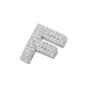 Macro shot of silver letter F pendant featuring brilliant micro-pave cubic zirconia stones