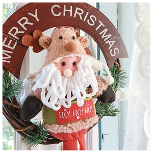 Detail of Santa and Reindeer plush figures on a wooden Christmas wreath hanger