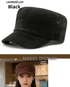 Detail view of suede cadet cap in black and brown featuring side metal eyelets