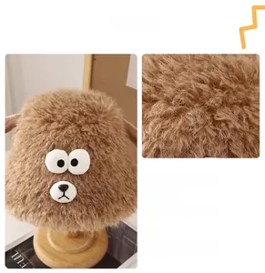 Detail of brown faux rabbit fur bucket hat with cute animal eyes and soft texture