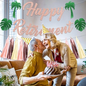 Rose gold Happy Retirement banner and palm leaf decor displayed in a cozy living room scene