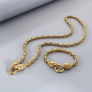 Detailed view of golden Byzantine chain necklace and bracelet set with lion head motifs