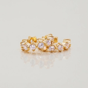 Macro shot of 18K gold plated stainless steel huggie hoops with sparkling white zircons