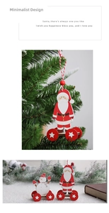 Detail of wooden Santa and Snowman ornaments with hanging rope and festive red wheels