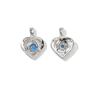 Macro detail of heart-shaped pendants with blue zircon and silver metal finish