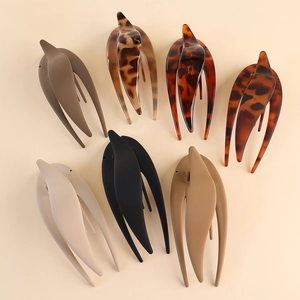 Flat lay of large matte duckbill hair clips in leopard print and solid neutral colors