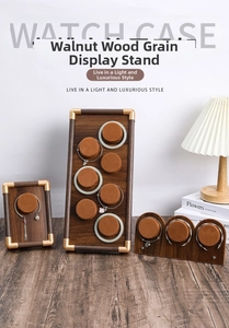 Detail view of walnut wood jewelry display set with gold corners and brown velvet pillows