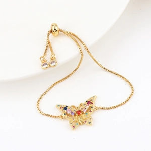 Close-up of gold butterfly bracelet with colorful zircon micro-inlays and bolo slider clasp
